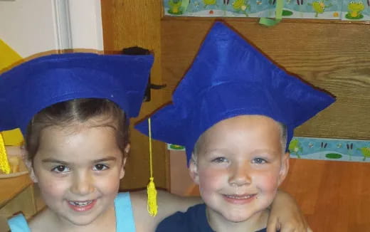 two boys wearing blue hats