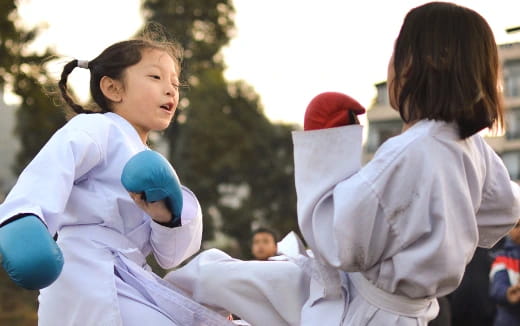 a few young girls in karate uniforms
