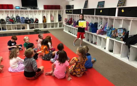 a group of children sitting on the floor in a room