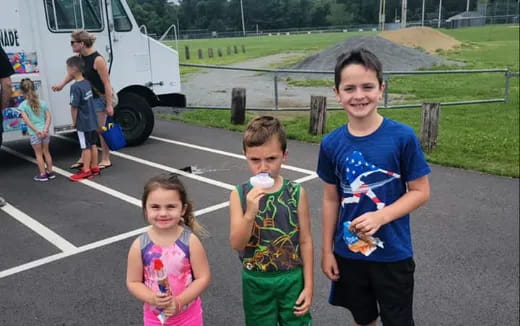 a group of people standing in a parking lot