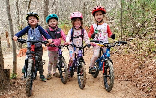 a group of kids on bikes in the woods