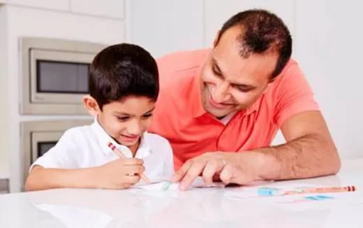 a person and a child looking at a paper