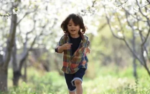 a child running in a forest