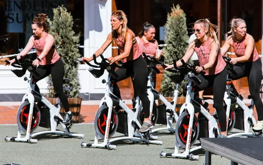 a group of women riding bicycles