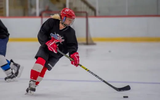 a person wearing a hockey uniform and helmet on ice