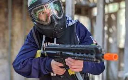 a person in a blue uniform holding a gun