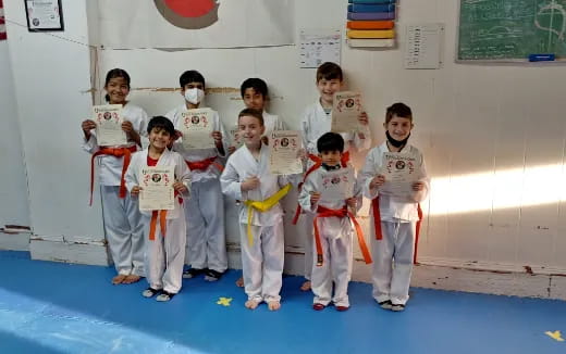 a group of kids in karate uniforms