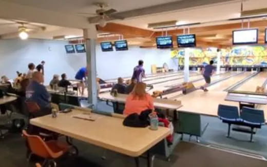 a group of people in a bowling alley