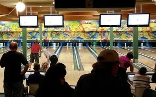 a group of people in a bowling alley