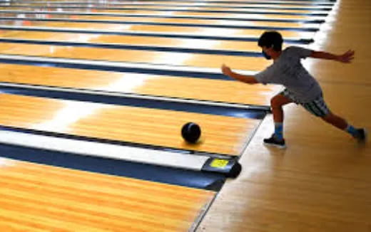 a boy playing bowling
