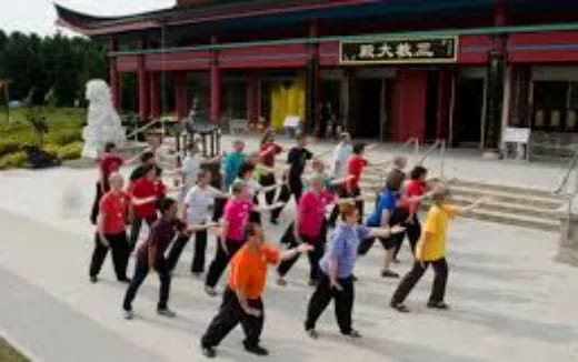 a group of people dancing outside a building