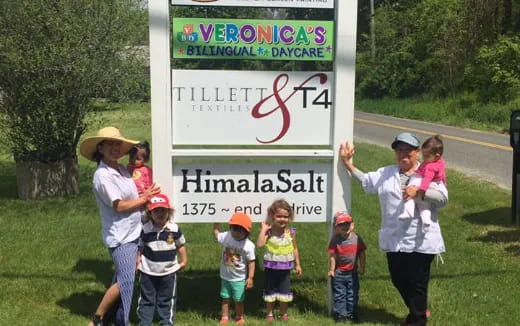 a group of children holding a sign