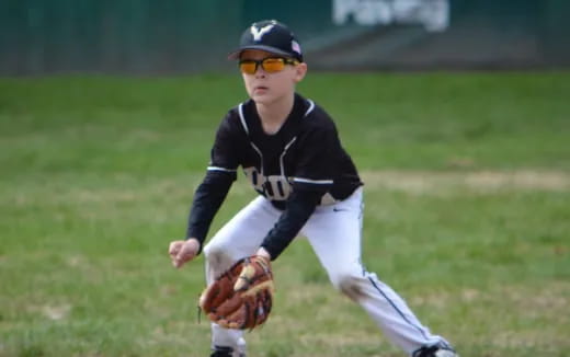 a young boy in a baseball uniform