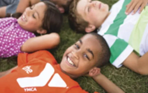 a group of children lying on the ground smiling