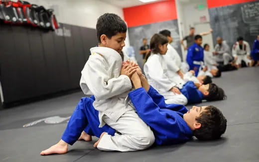 a group of children in karate uniforms