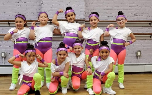 a group of girls in matching outfits