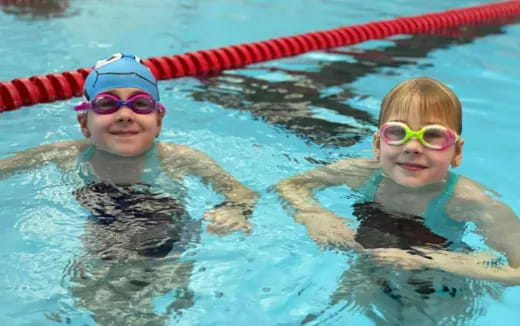 a couple of kids in a pool