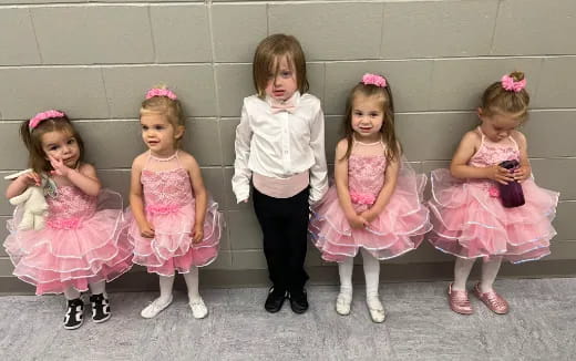 a group of girls in dresses