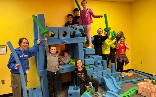 a group of children on a toy train