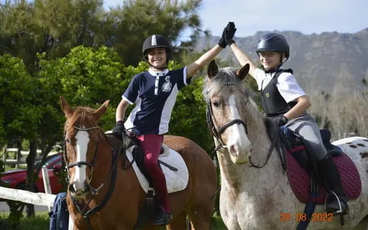 a couple of people riding horses