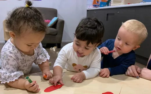 a group of children sitting at a table