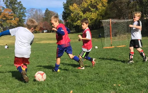 a group of kids playing football