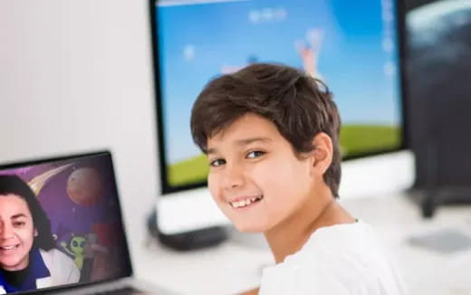 a person smiling in front of a computer screen