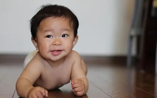 a baby crawling on the floor