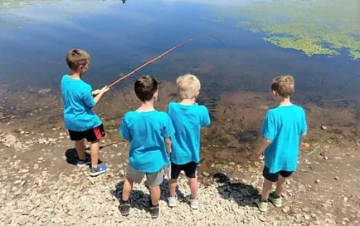 a group of children fishing