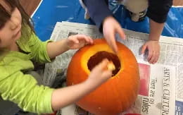 a person holding a pumpkin