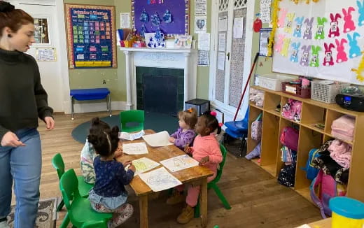 a person and children in a classroom