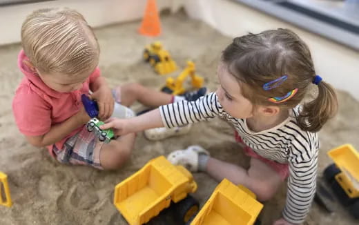 a couple of children playing with toys