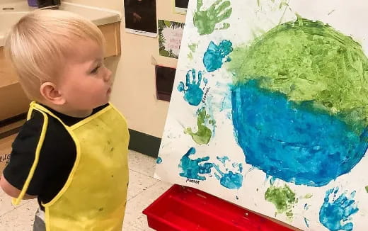 a child looking at a painting