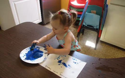 a little girl eating cake