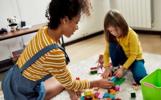 a person and a child playing with toys