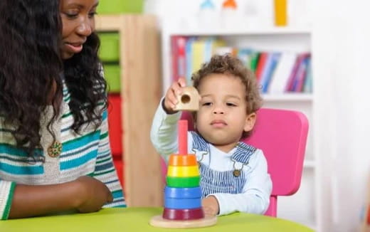 a person and a child sitting at a table