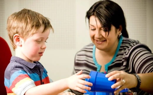 a person and a child looking at a tablet