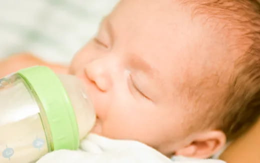 a baby drinking from a bottle