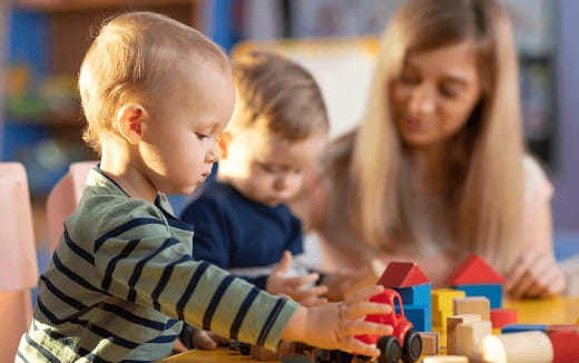 a person and two children playing with toys