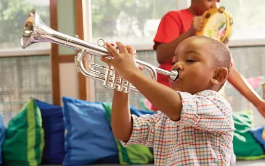 a baby drinking from a glass