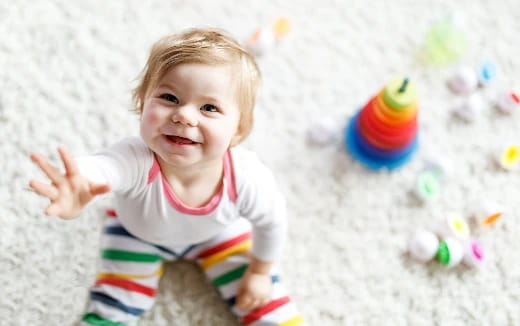 a baby in a pile of toys