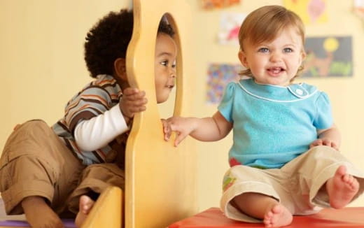 a few children sitting on a yellow couch