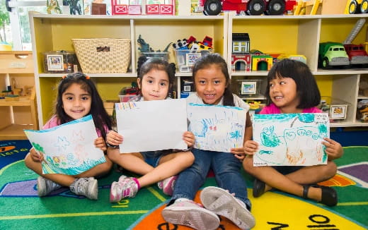 a group of children holding up books