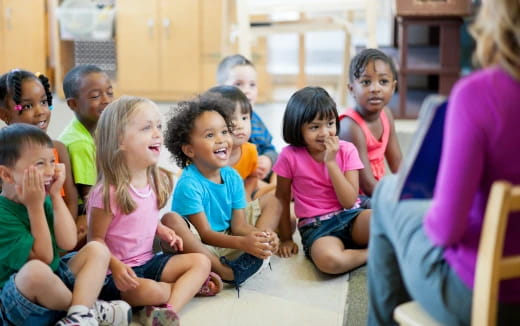 a group of children sitting in a classroom