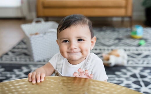 a baby lying on a rug