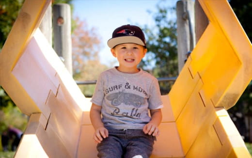 a boy standing on a playground