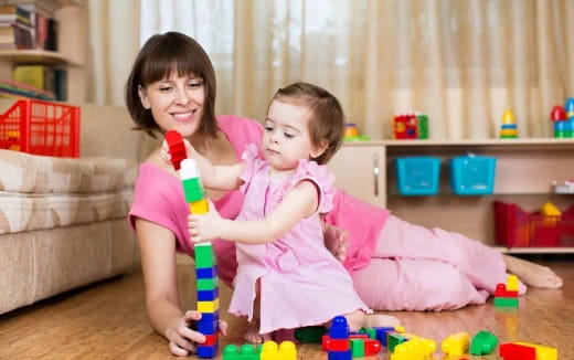 a person and a child playing with toys