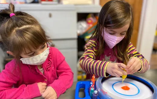 a couple of girls playing with toys