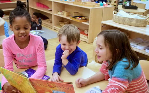 a group of children sitting on the floor reading books