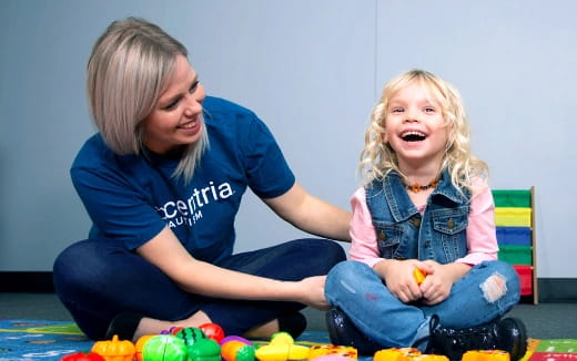 a person and a child playing with toys